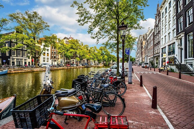 Amsterdam Day Trip from Brussels With Cheese, Clogs and Windmills - The city walk: Royal Palace frontage, waterways, and the canal-adjacent feel